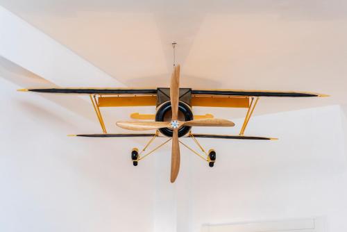 a biplane hanging from a ceiling at NG Guest House l'Acquedotto in Olbia