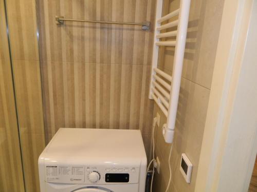 a small bathroom with a toilet and a shower at orbi beach tower in Itʼkhvisi