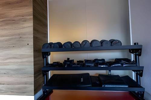 a shelf of boxing equipment in a room at Flat completo e aconchegante - Granja Viana in Cotia