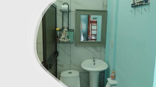 a bathroom with a sink and a mirror at Villa Blue Vacations in Parrita