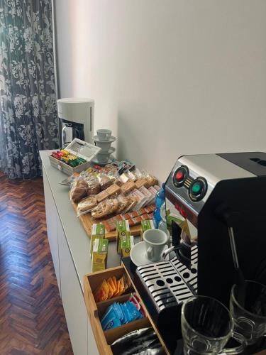 a counter with a table with food and a coffee machine at B&B Lary in Pescara