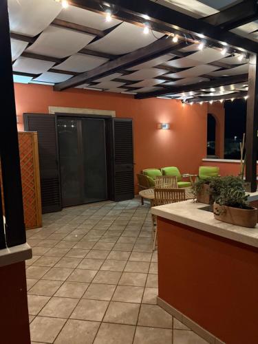 a lobby with a bar and chairs and lights at Villaelena Salento Mare in Marittima