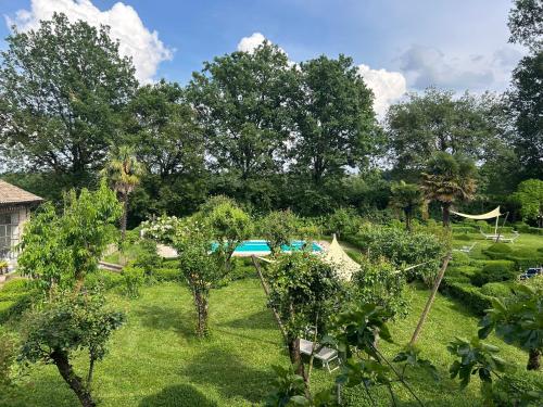 a view of a garden with trees and a tent at Le dimore de Il borgo del balsamico in Albinea