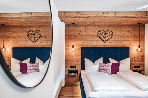 two beds in a room with hearts on the wall at Landhaus Rohrmoser in Zell am Ziller