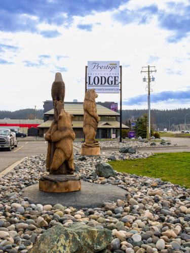 two statues of two bears standing in front of a store at Prestige Prince George Lodge in Prince George