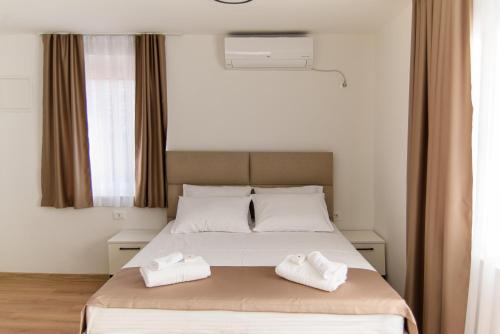 a bedroom with a bed with two towels on it at Carmen Old Town Apartments in Sarajevo