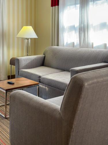a living room with two couches and a table at Prestige Prince George Lodge in Prince George