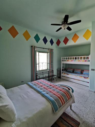 a bedroom with a bed and a ceiling fan at Al Fundok Boutique Hotel in Maasser El Chouf