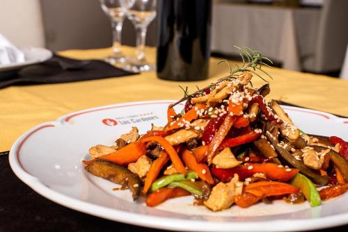a plate of food with vegetables on a table at Hotel Termal Los Cardones & Spa in Termas de Río Hondo