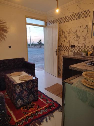 a kitchen with a table in the middle of a room at Kaouki Beachside Apartment 3 peoples in Essaouira