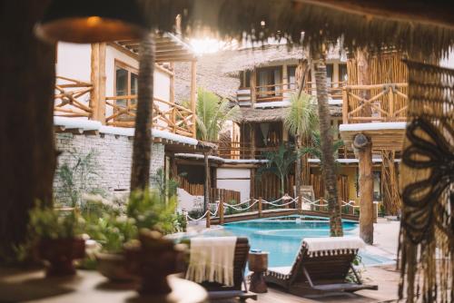 a resort with a swimming pool and a building at Casa Las Tortugas Petit Beach Hotel & Spa in Holbox Island