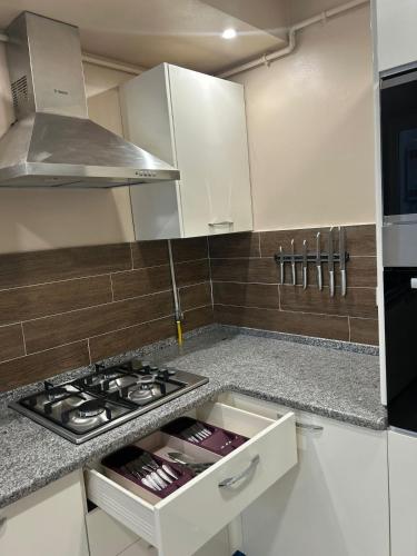 a kitchen with a stove and a counter top at Luxurious apartment Lina in Hiboun