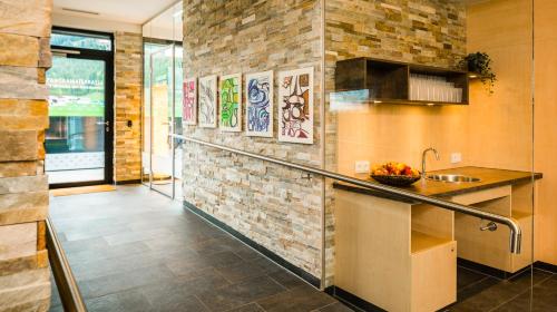 a kitchen with a counter and a brick wall at Ferienwohnungen Guthof in Schattwald