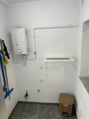 a small white bathroom with a toilet and a towel dispenser at Luxurious apartment Lina in Hiboun