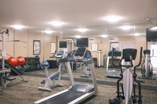 a gym with treadmills and exercise bikes and mirrors at Staybridge Suites Austin Airport by IHG in Austin