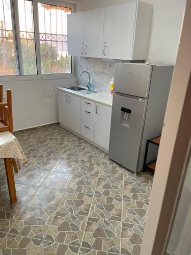 a kitchen with a refrigerator and a sink at Traceys 3 Apartments Borsh in Borsh