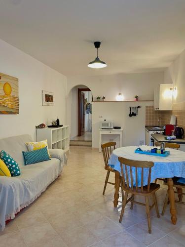 a living room with a couch and a table at Casa Anita-relax e comodità in Cala Gonone