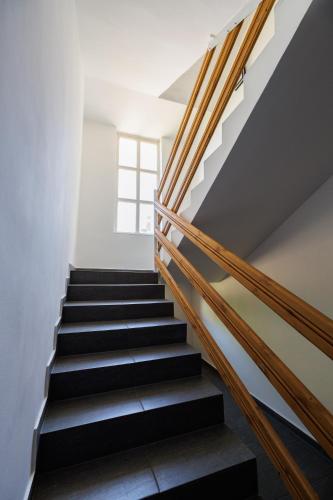 a staircase in a house with a window at Deluxe Design Apartman in Debrecen