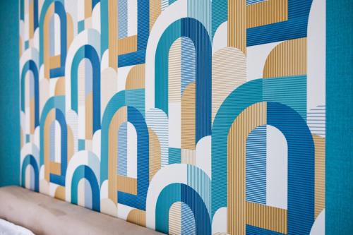 a wall mural with blue and orange at Deluxe Design Apartman in Debrecen