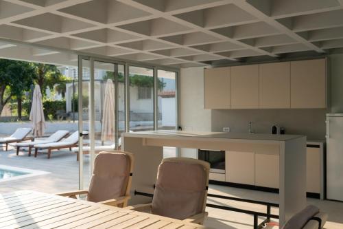 a kitchen with a table and chairs and a patio at Old Vineyard Estate in Buna
