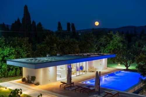 a house with a swimming pool at night at Old Vineyard Estate in Buna