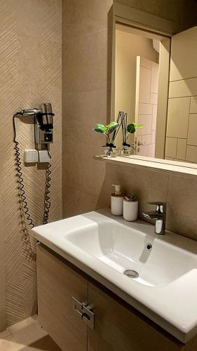 a bathroom with a white sink and a mirror at Tamraght cosy stay in Tamraght Ouzdar