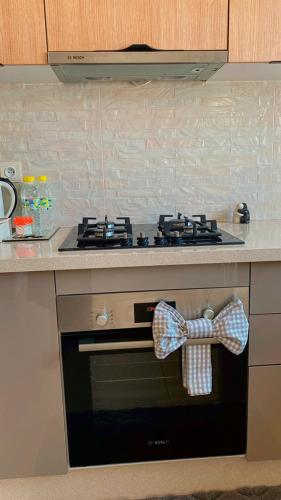 a bow tie hanging on a stove in a kitchen at Tamraght cosy stay in Tamraght Ouzdar
