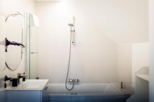 a bathroom with a tub and a sink and a shower at Hostel Charino in Pontevedra