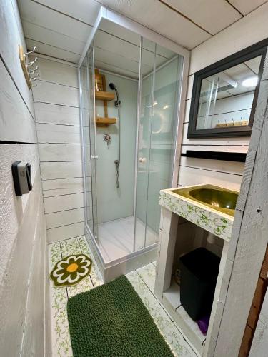 a small bathroom with a shower and a sink at Gite tente LOTUS in Montesquieu