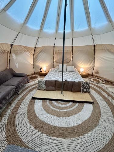 a bedroom with a bed in a tent at Gite tente LOTUS in Montesquieu