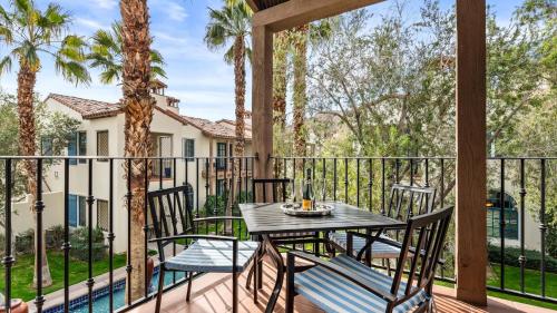 a patio with a table and chairs on a balcony at LV369 Stylish Upstairs 3BR 3BA LV Condo Near Pool in La Quinta