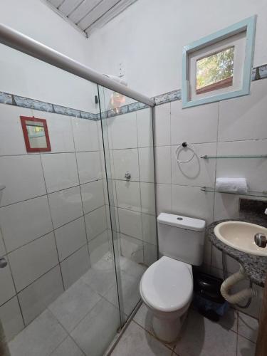 a bathroom with a shower and a toilet and a sink at Casa Canto Verde in Itacaré