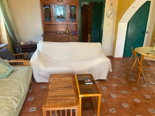 a living room with a couch and a table at La Lampara sul Mare in Torrenova