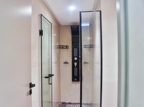 a glass shower in a building with a sign on the wall at Studio de charme face corniche de Casablanca in Casablanca