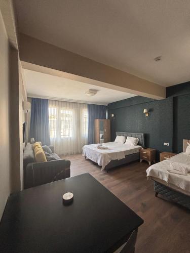 a hotel room with two beds and a table at DUUM suite in Karşıyaka