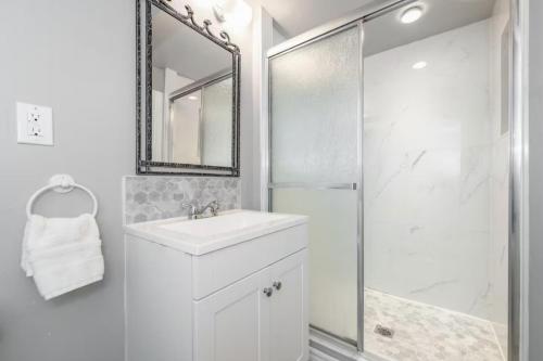 a white bathroom with a sink and a shower at Bungalow Home in Ottawa