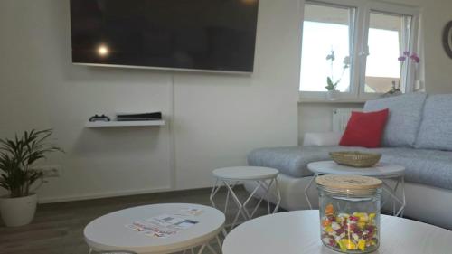 a living room with a couch and two tables at HAPPY HOMES FUN - Up to 8 - Küche - W-LAN - Netflix - PS5 - Badewanne in Altenstadt
