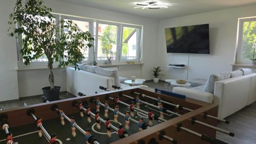a living room with a large chess board on the floor at HAPPY HOMES FUN - Up to 8 - Küche - W-LAN - Netflix - PS5 - Badewanne in Altenstadt