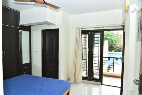 a room with a blue table and a door at 2 Bedroom Family apartment in cooke town in Bengaluru