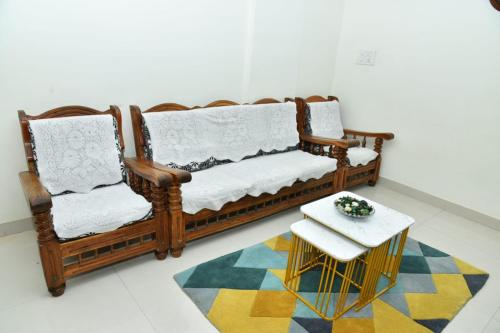 a living room with a couch and a table at 2 Bedroom Family apartment in cooke town in Bengaluru