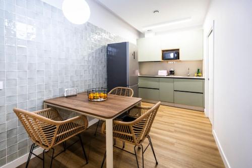 a kitchen and dining room with a table and chairs at Hostel Charino in Pontevedra