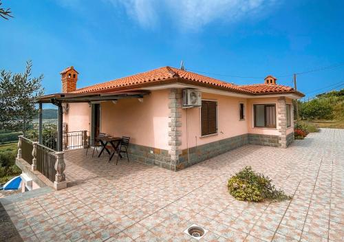 a small house with a patio in front of it at 4 Roses Residence in Sečovlje