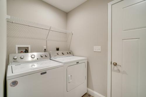 a white laundry room with a washer and dryer at Wraparound Porch Home Near Dtwn Crossville! in Crossville