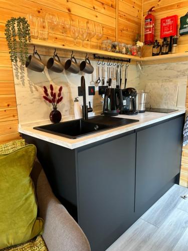 a kitchen with a sink and a counter at River Huts with Private Hot Tubs in Inverness