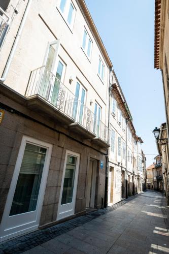an empty street in a city with a building at Hostel Charino in Pontevedra