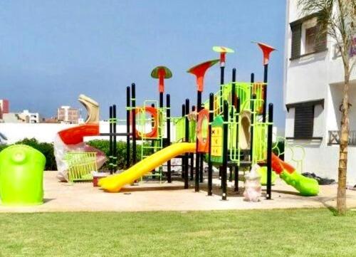a playground with a slide in a park at Charm & Pool near Beach in Oued Laou