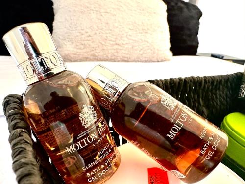 a bottle of liquor sitting on a table next to at Beautiful Spacious Kingsize Room Near Oval Station in London