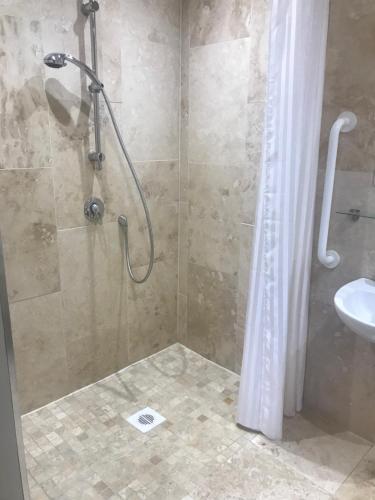 a bathroom with a shower and a sink at Aspen Lodge in Oban
