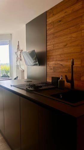 a kitchen with a counter with a keyboard and a sink at AMoR in Salò