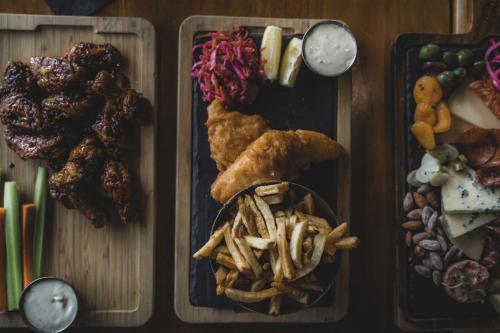 a tray of food with chicken wings and french fries at Black Rock Oceanfront Resort in Ucluelet
